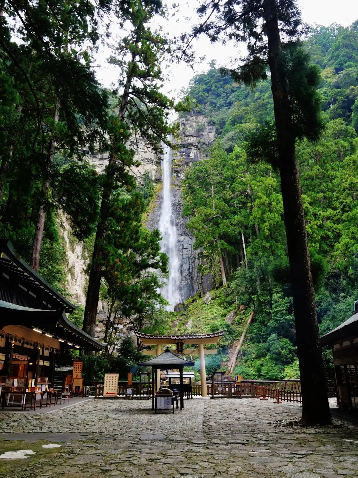 The grounds of Hiro Shrine with its torii, and Nachi Falls behind